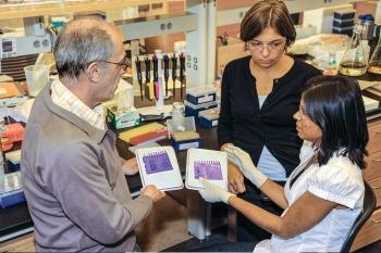 A young startup founder at CBiRC, at right, confers with colleagues