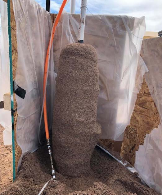 Biocemented sand column created using CBBG's patented enzyme-induced carbonate precipitation process.