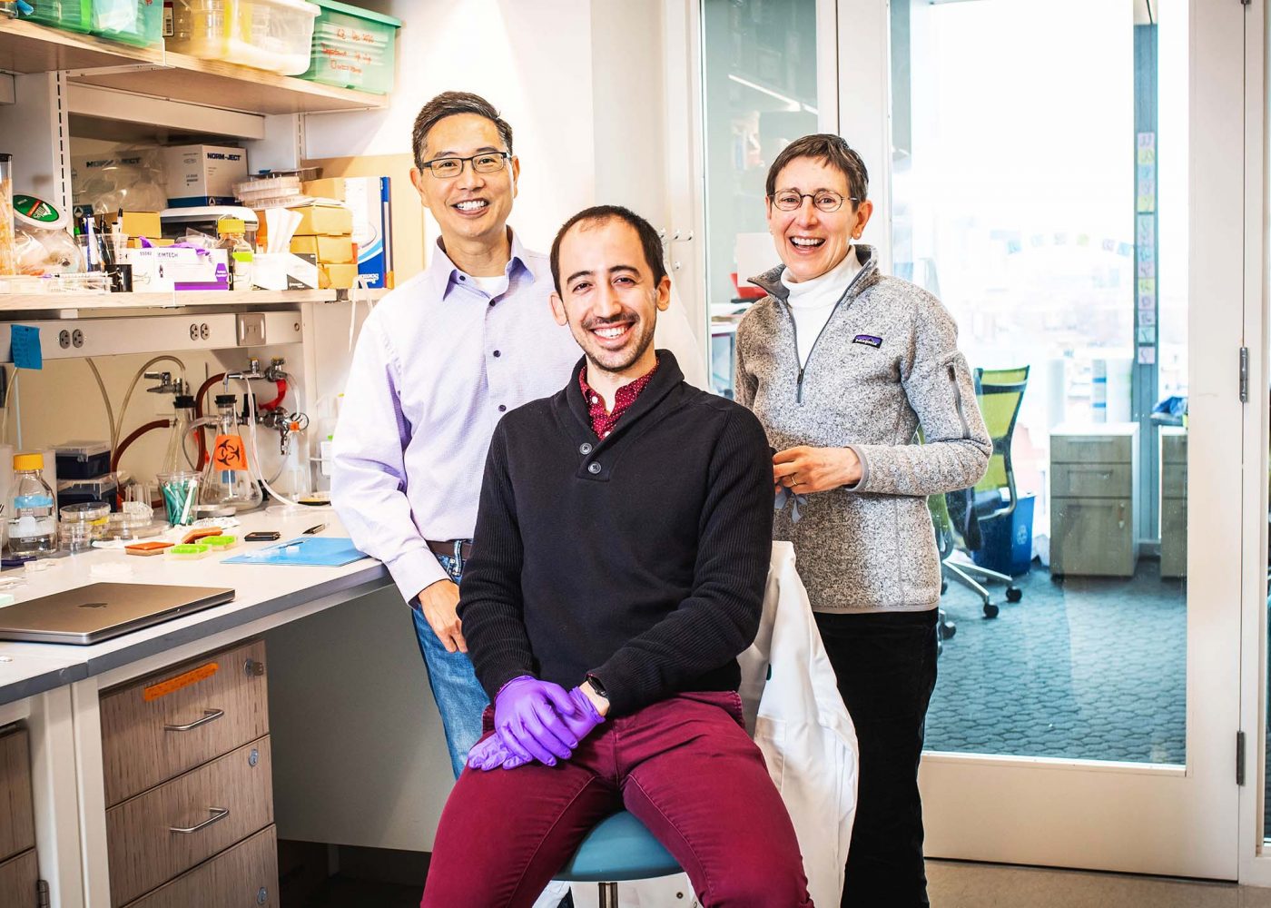 Figure 1. Photo of Dr. Chris Chen (left) postdoc (and former Ph.D. student) Christos Michas (center), and Dr. Alice White in their lab in March 2022.